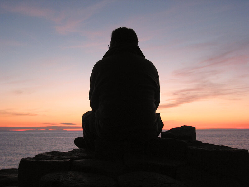 Person silhouetted at sunset