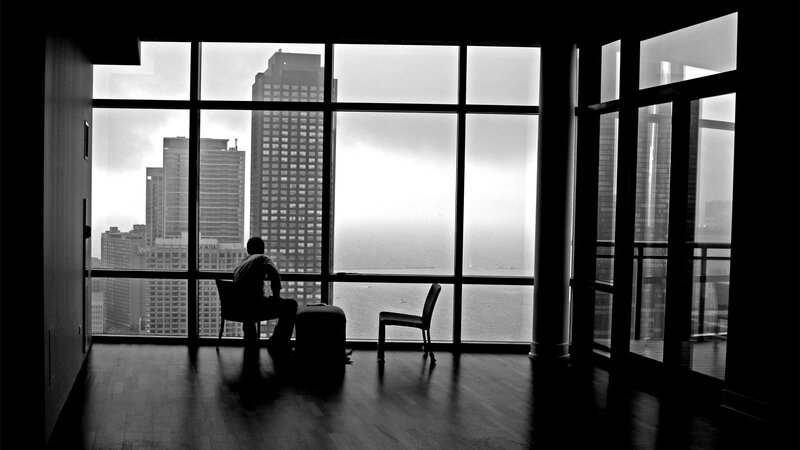 Person silhouetted by city view