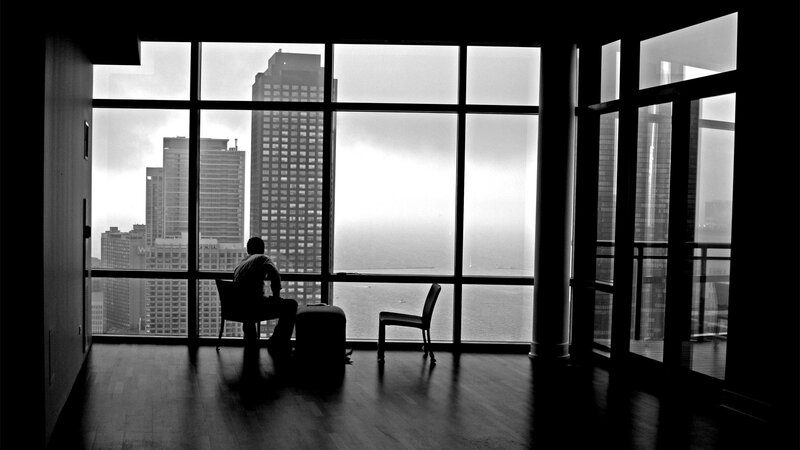 Person silhouetted by city view