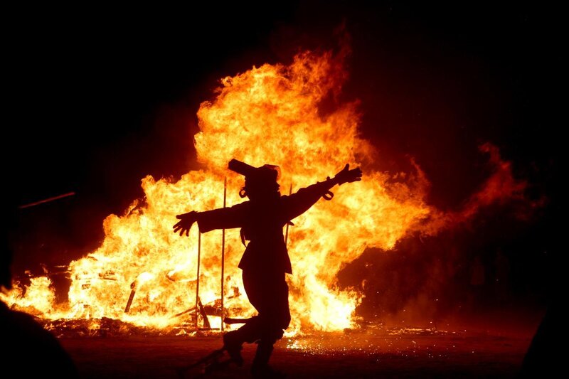 Person silhouetted by fire