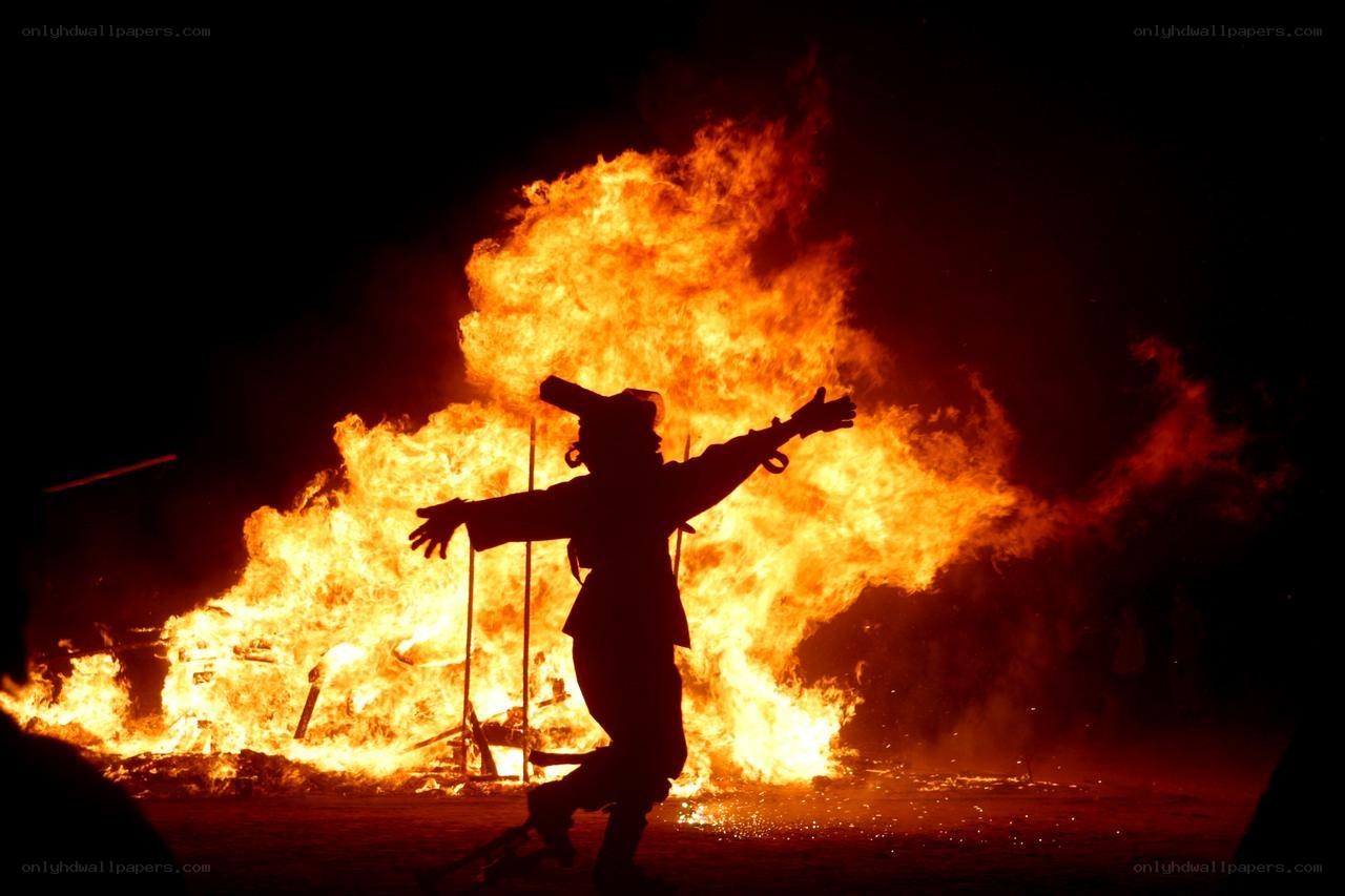 Person silhouetted by fire