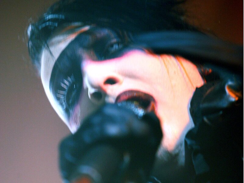 Person Singing into Microphone — Black, Dramatic, Photograph, Stage Lighting
