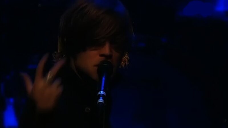 Person Singing into Microphone — Blue