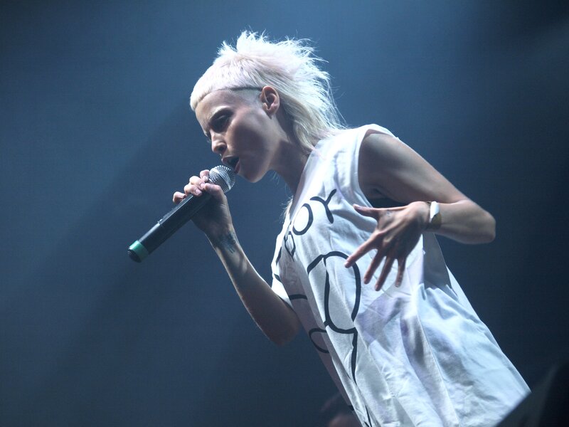 Person Singing into Microphone — White