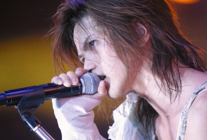 Person Singing into Microphone — Yellow