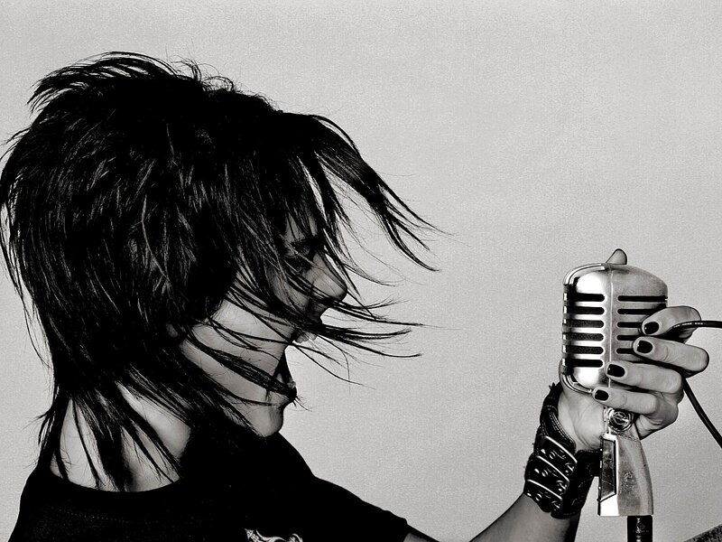 person singing into vintage microphone