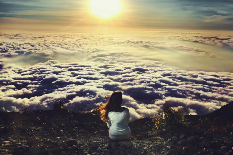 Person sitting above the clouds