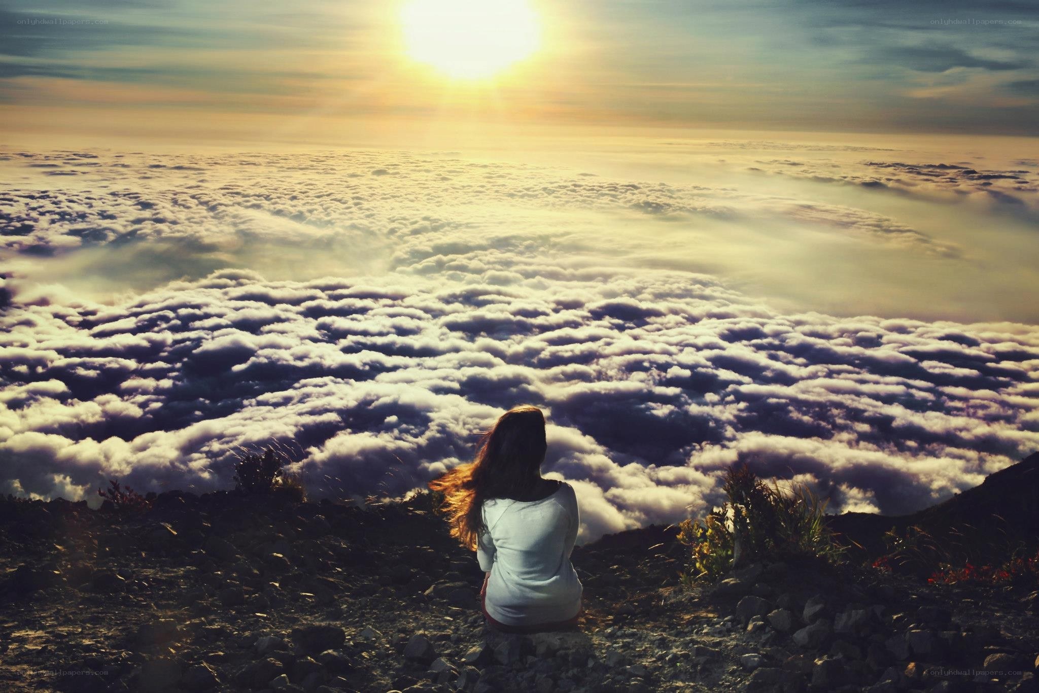 Person sitting above the clouds