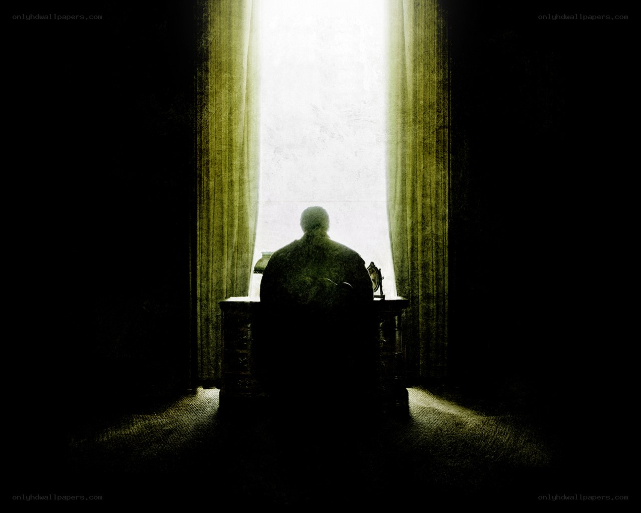 person sitting at desk by window