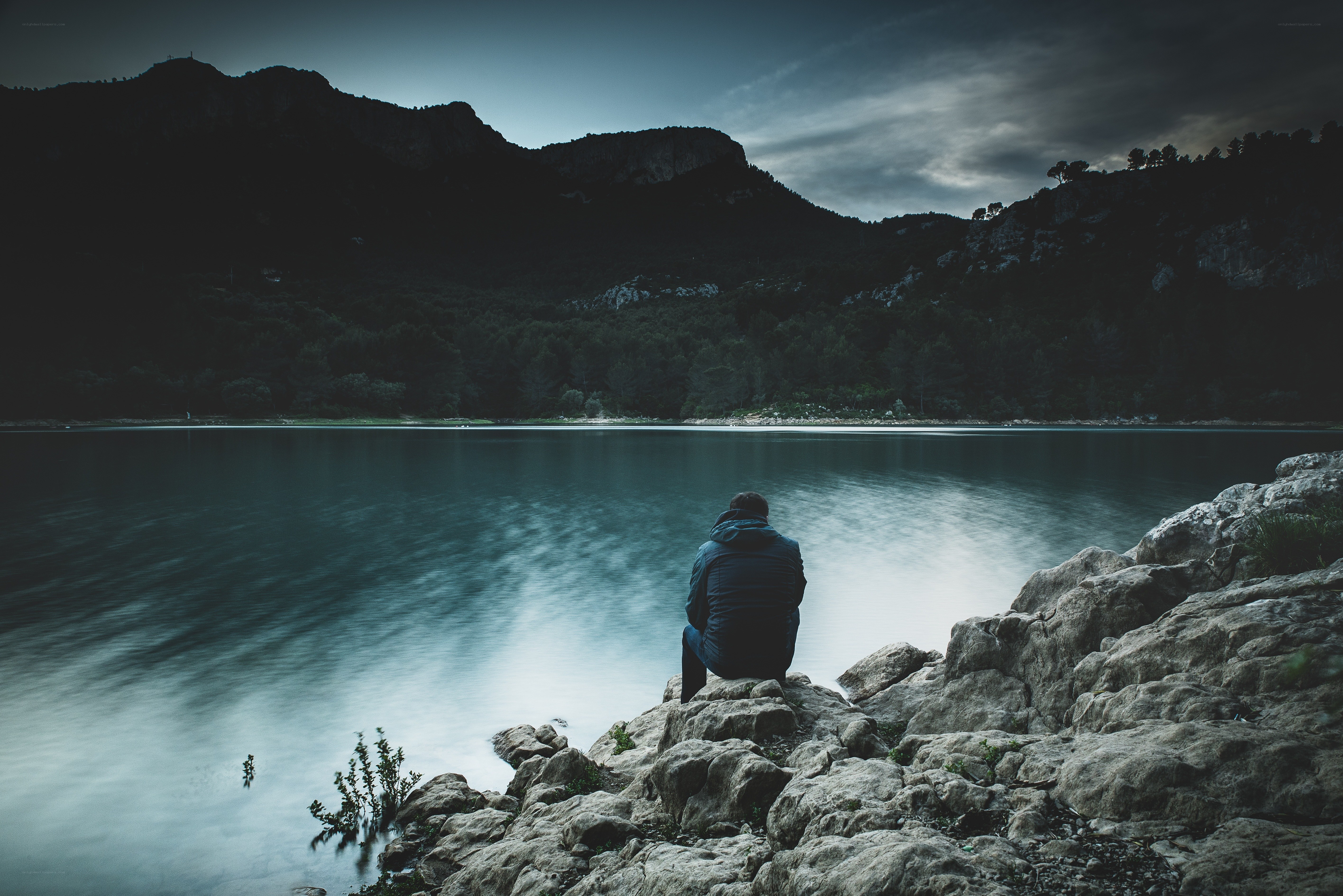 person sitting by a lake