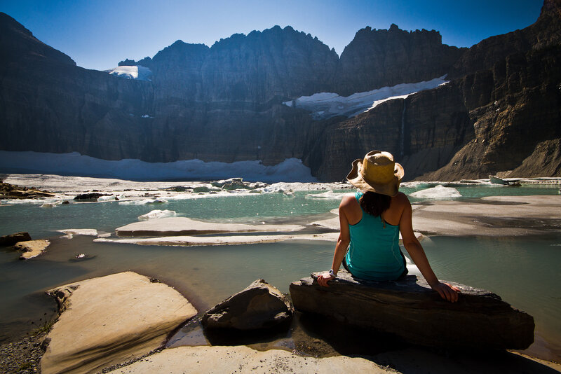 Person Sitting by Glacier Lake