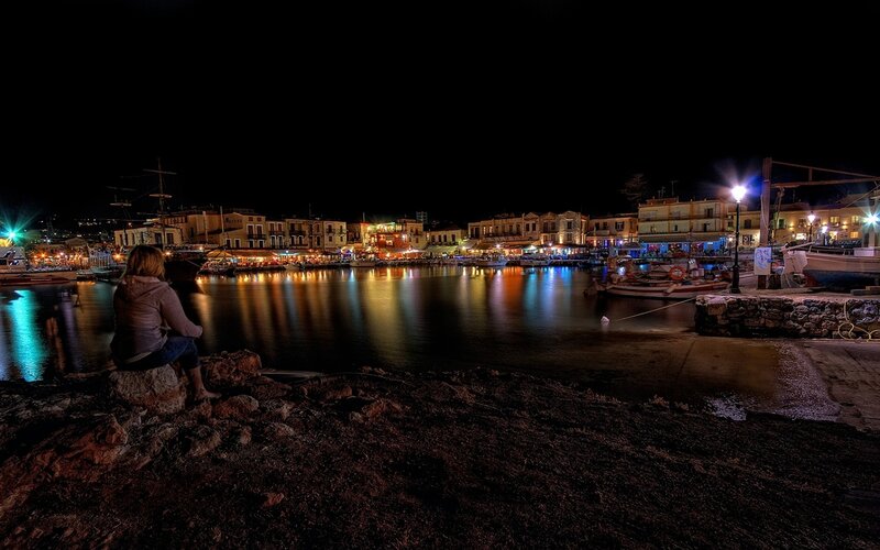 Person Sitting by Harbor