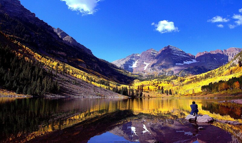 Person Sitting by Lake — Blue, Serene, Autumn