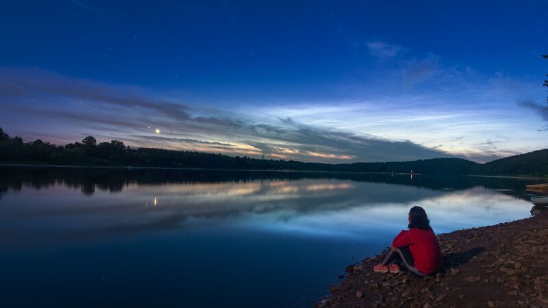 Person Sitting by Lake — Blue, Serene, Night