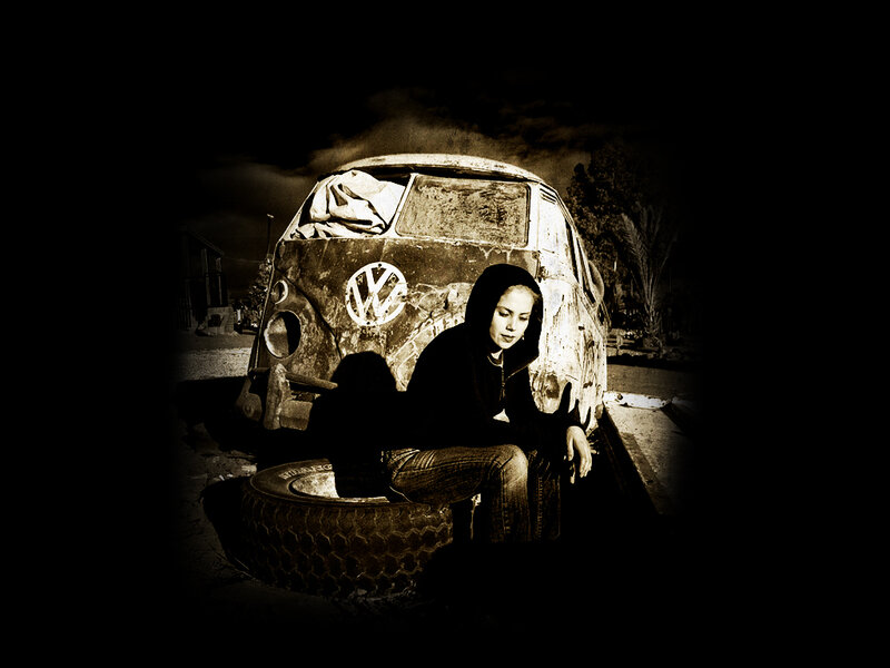 person sitting by old van