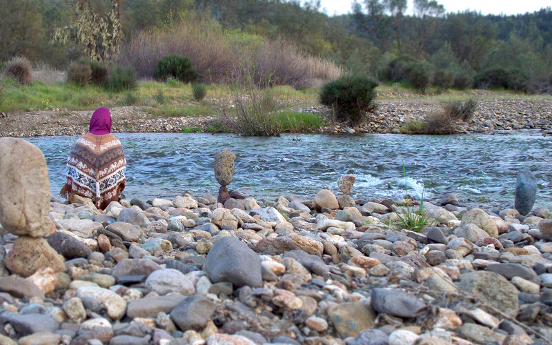 Person Sitting by River — Brown