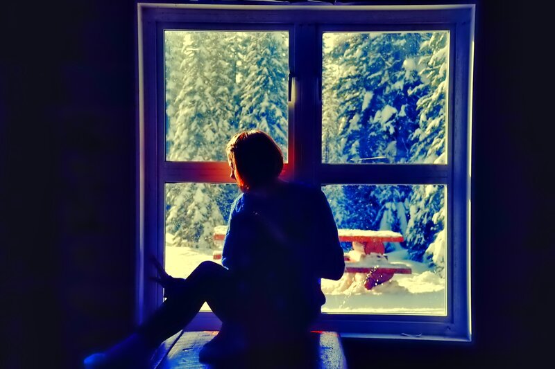 Person Sitting by Window — Blue