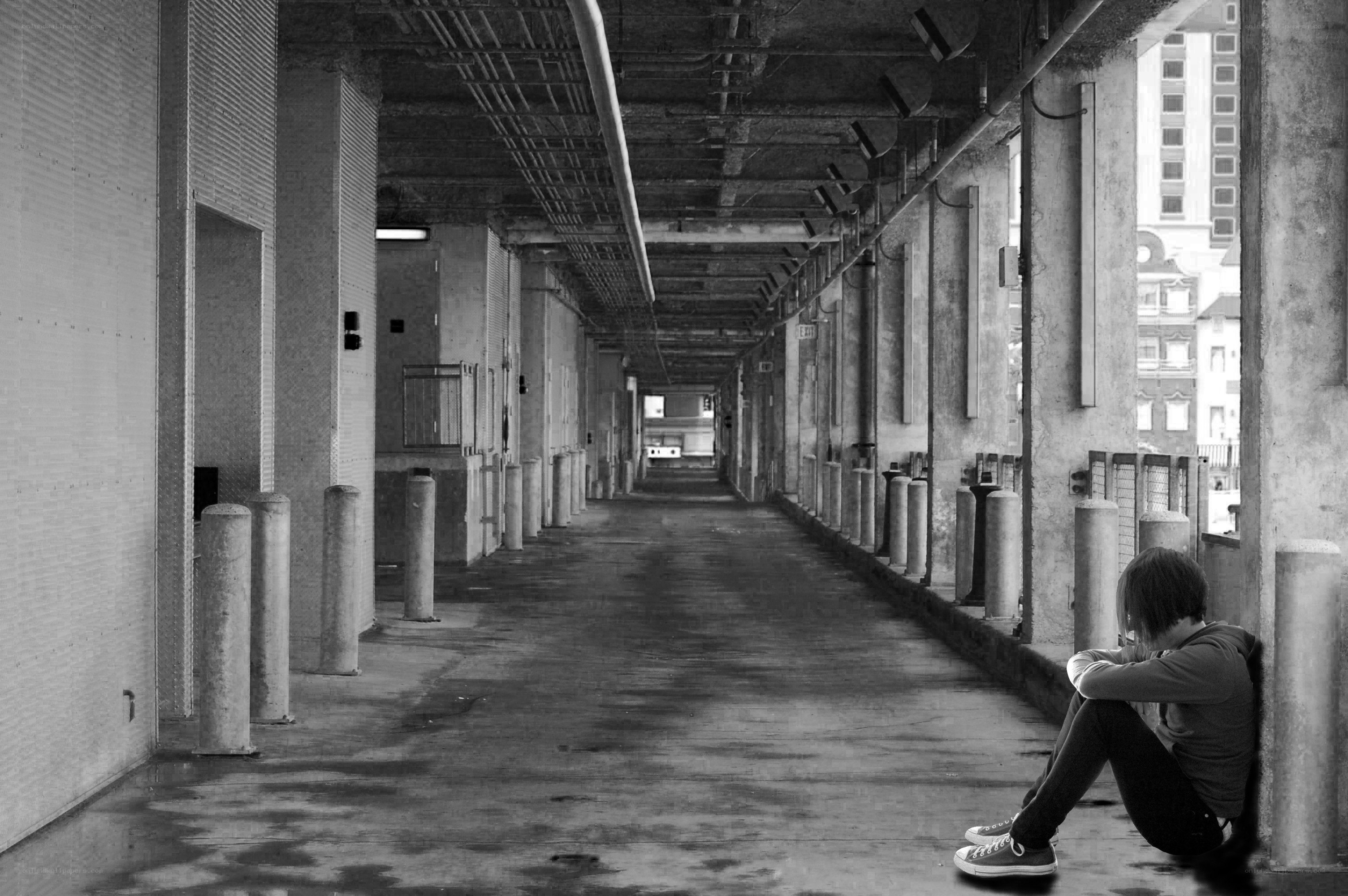 person sitting in a corridor