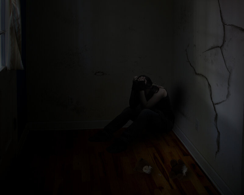 person sitting in dark room
