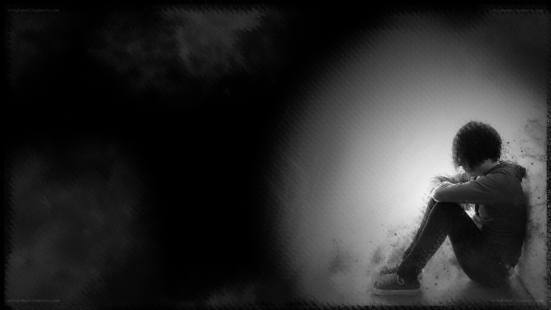 person sitting in darkness