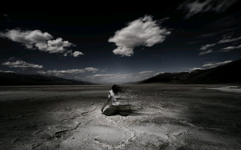 Person Sitting in Desert — Black