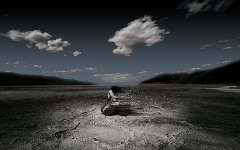 person sitting in desert landscape