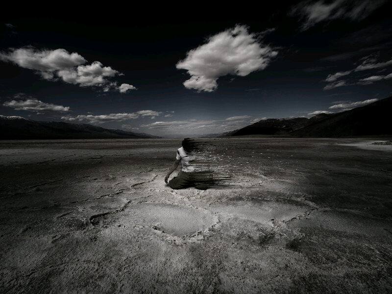 Person Sitting in Desert