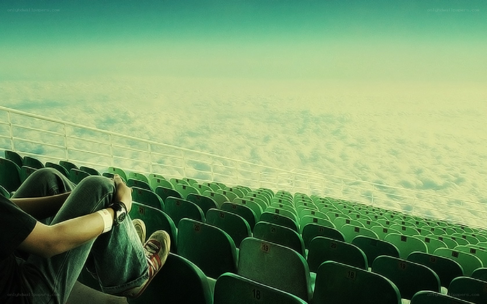 person sitting in empty stadium