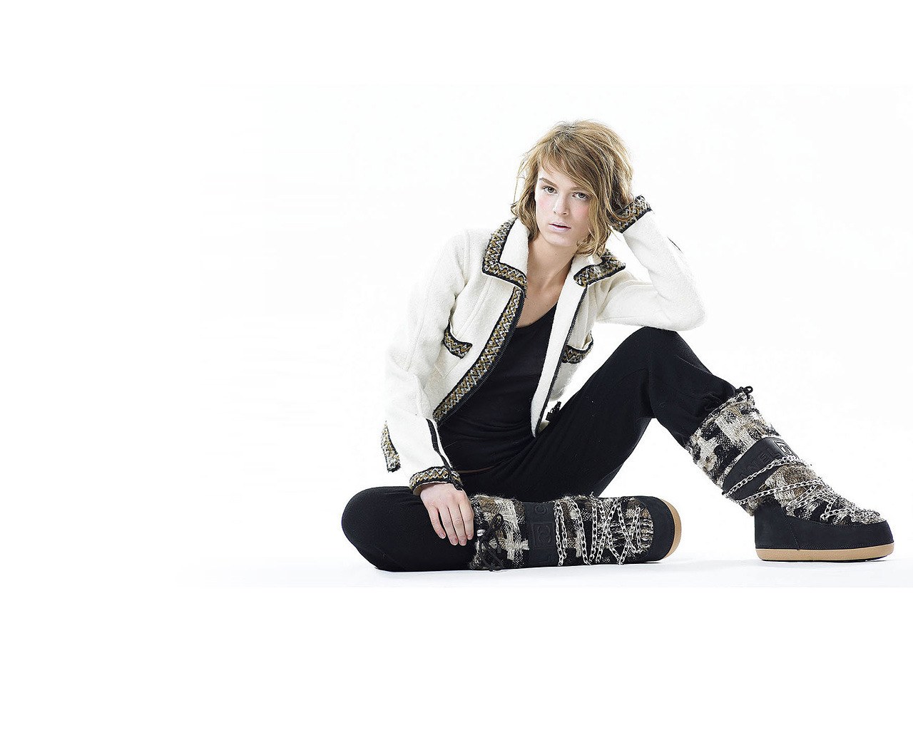 person sitting in winter boots