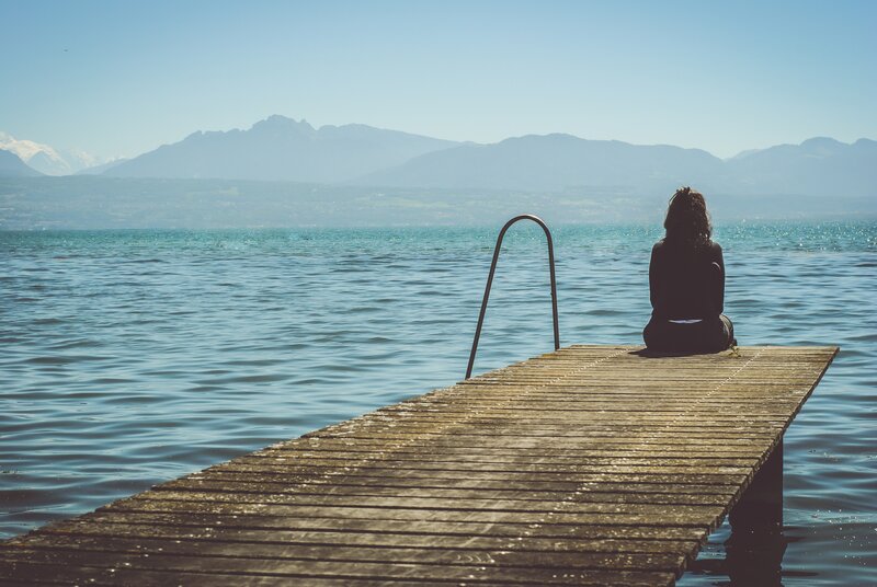 Person sitting on a dock