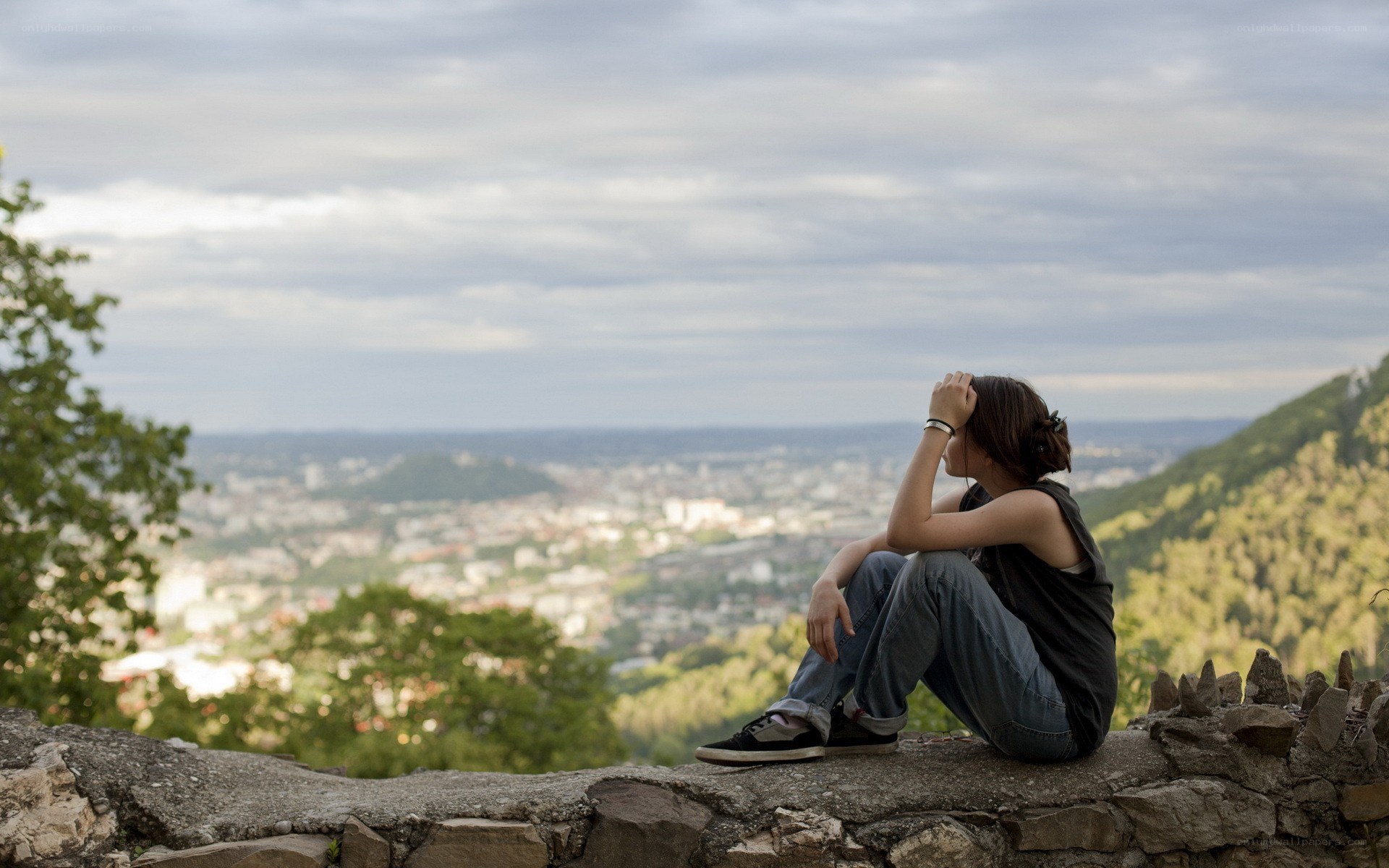 Person sitting on a wall