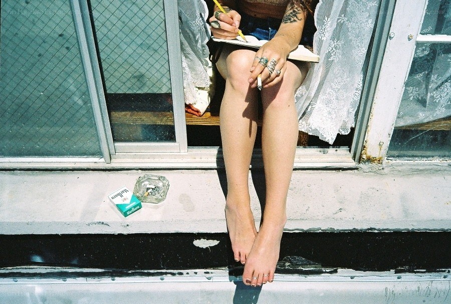 person sitting on a windowsill