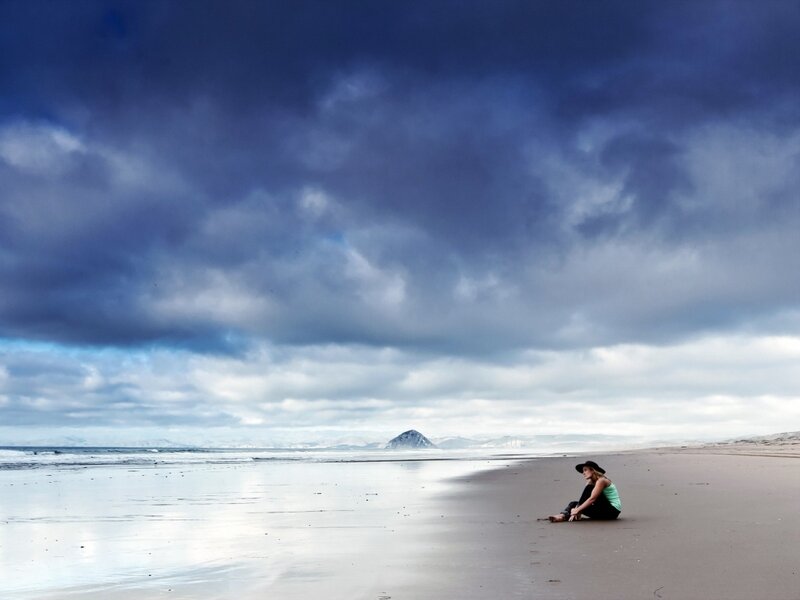 Person Sitting on Beach — Blue, Dramatic, Photograph