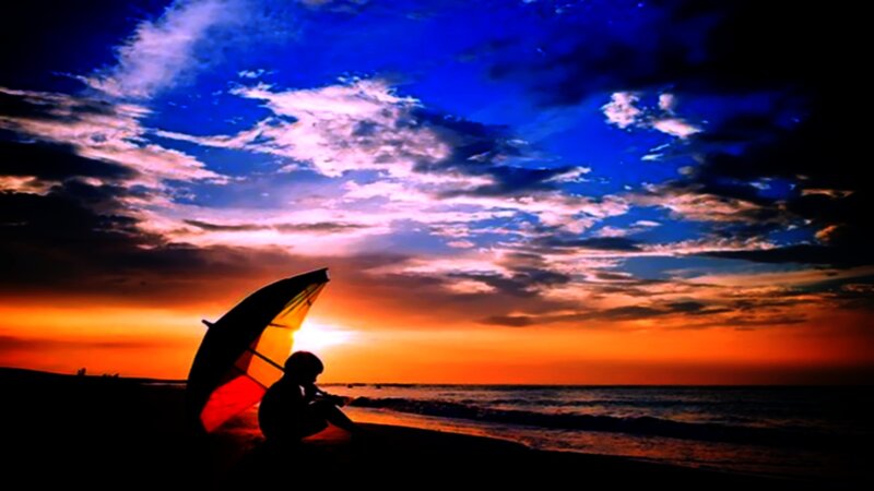 Person Sitting on Beach — Blue, Dramatic, Sunset