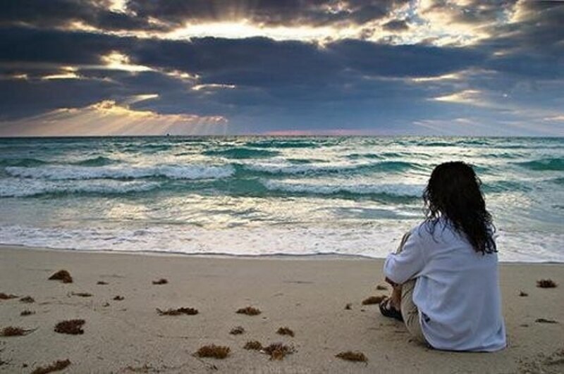 Person Sitting on Beach — Blue, Dramatic