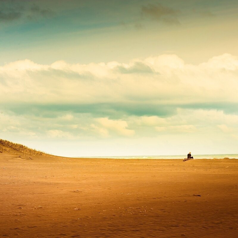 Person Sitting on Beach — Brown, Serene, Afternoon