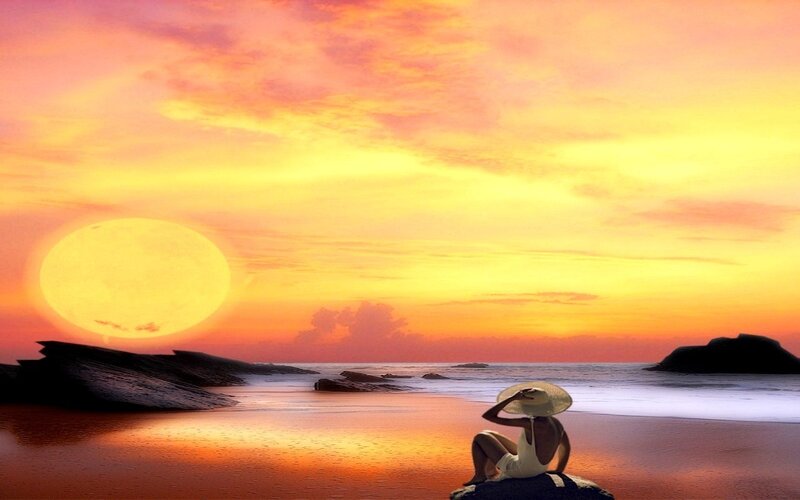 Person Sitting on Beach — Orange