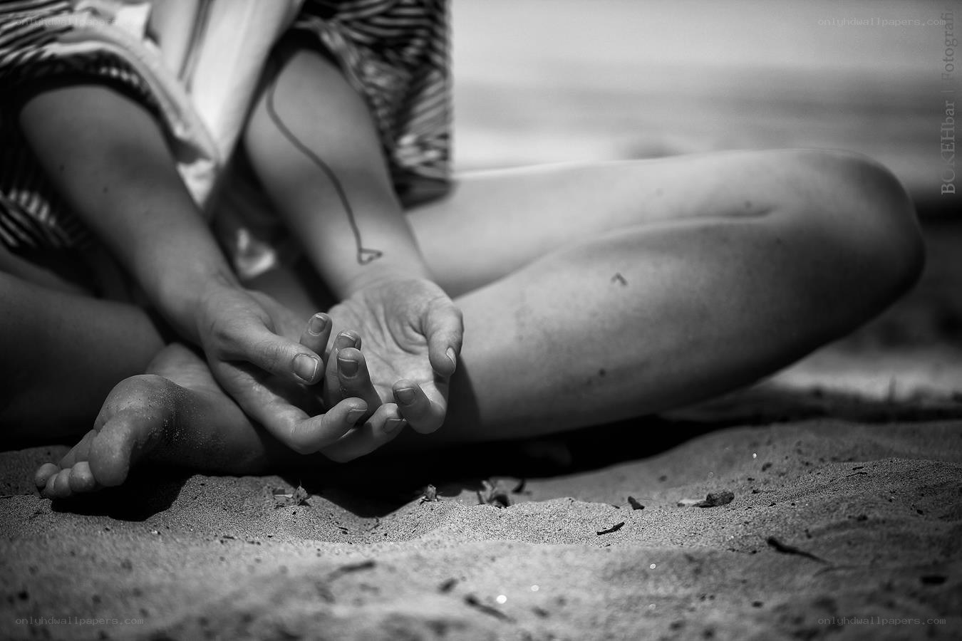 person sitting on beach sand