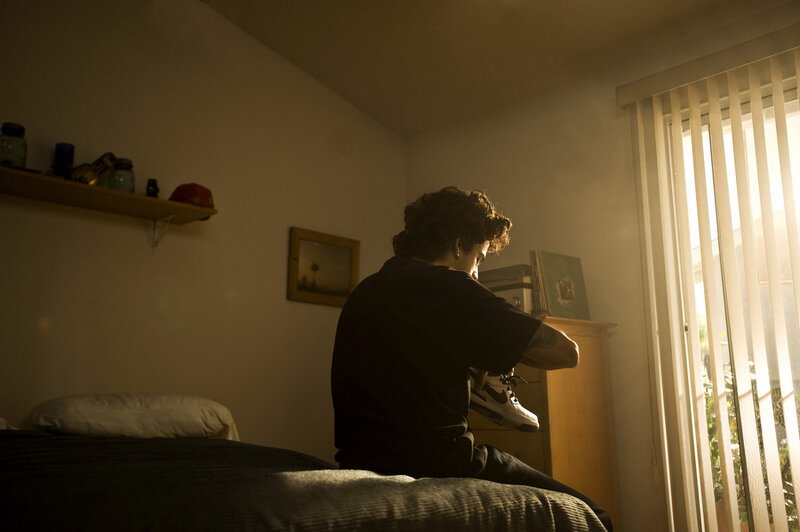 Person Sitting on Bed — Brown