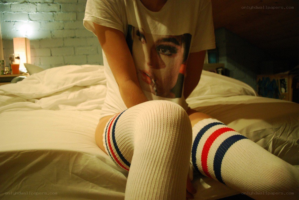 person sitting on bed in socks
