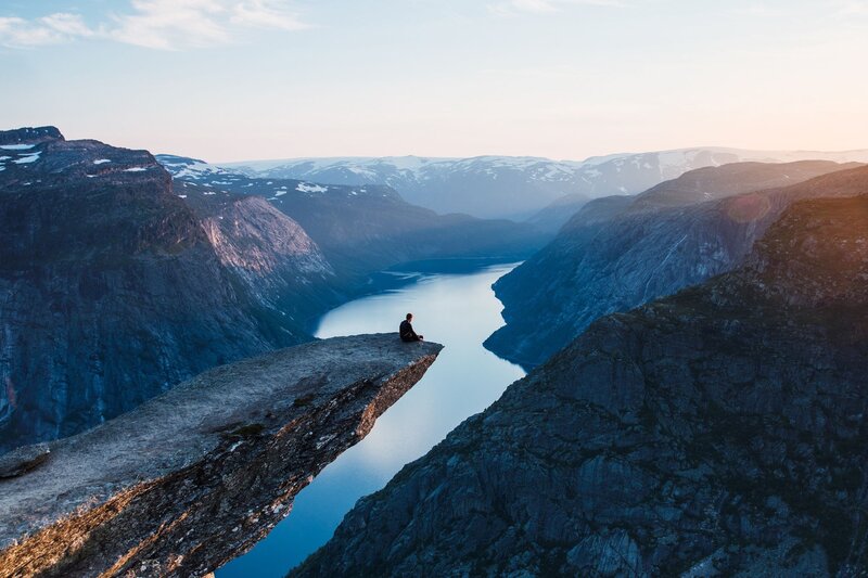 Person Sitting on Cliff — Blue, Serene, Sunset