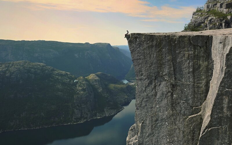 Person Sitting on Cliff — Gray