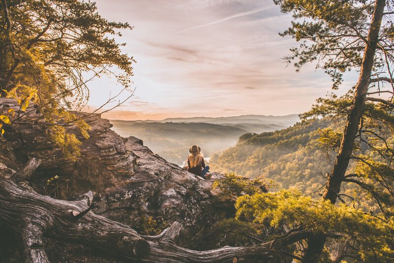 Person Sitting on Cliff — Green
