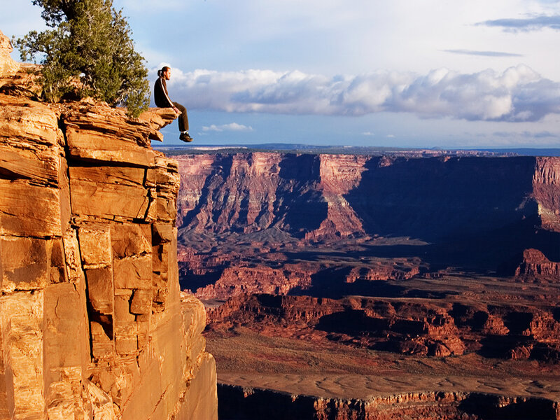 Person Sitting on Cliff — Red