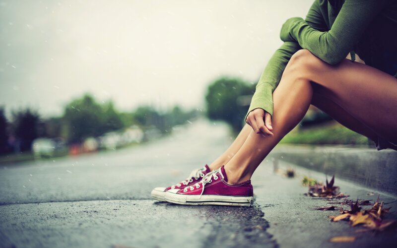 Person Sitting on Curb