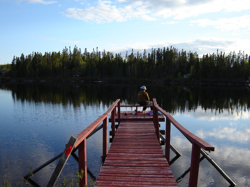 Person Sitting on Dock — Blue, Serene, Afternoon
