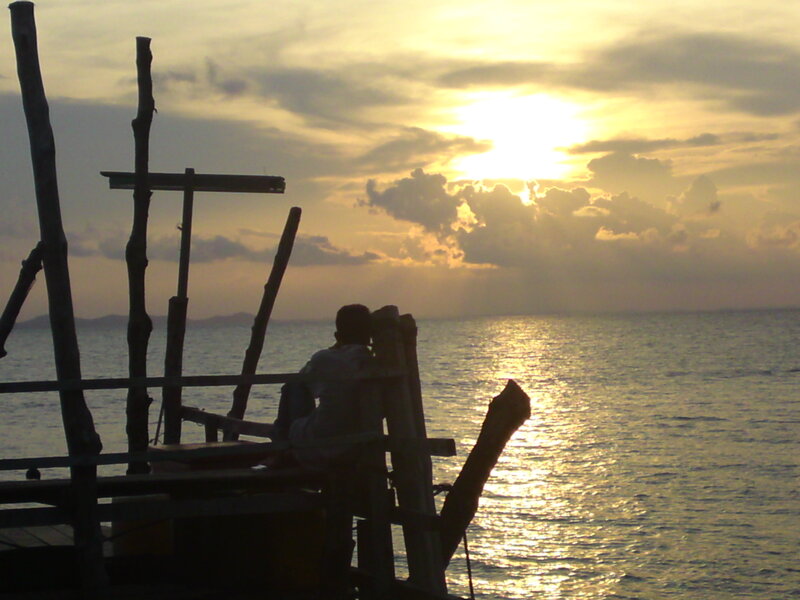 Person Sitting on Dock — Yellow