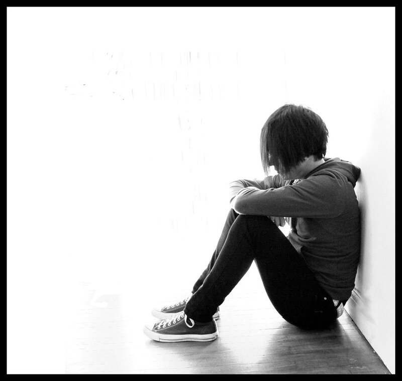 person sitting on floor in silhouette