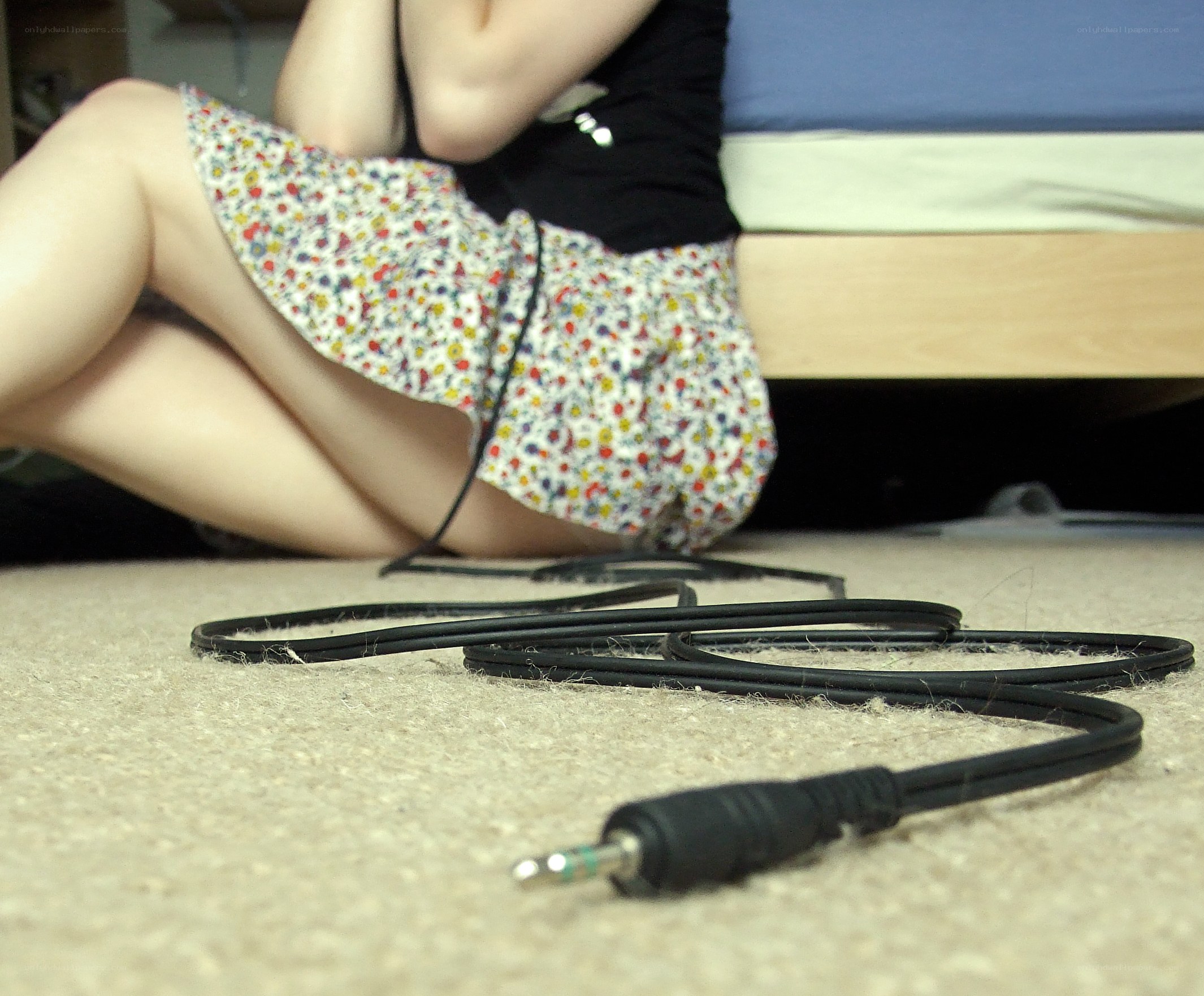 person sitting on floor with cable