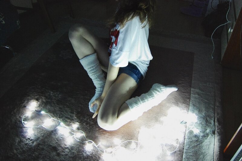 person sitting on floor with lights